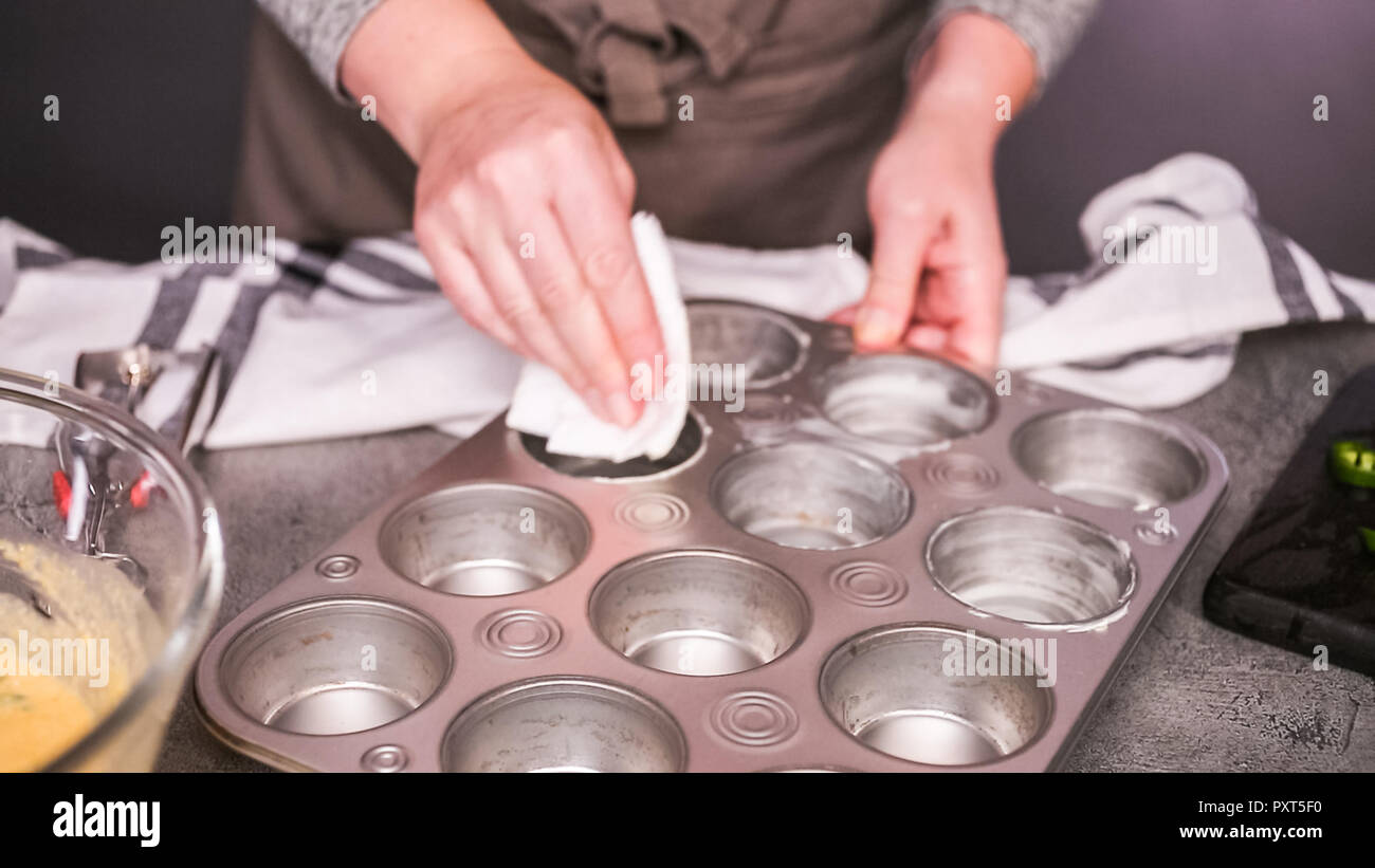 Step by step. Greasing muffin pan for baking spicy jalapeno cornbread