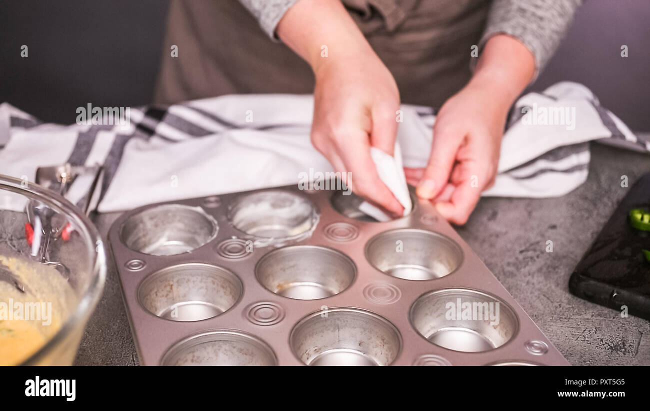 Step by step. Greasing muffin pan for baking spicy jalapeno cornbread
