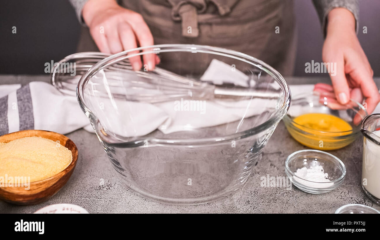 Step by step. Mixing ingredients together in glass mixing bowl for