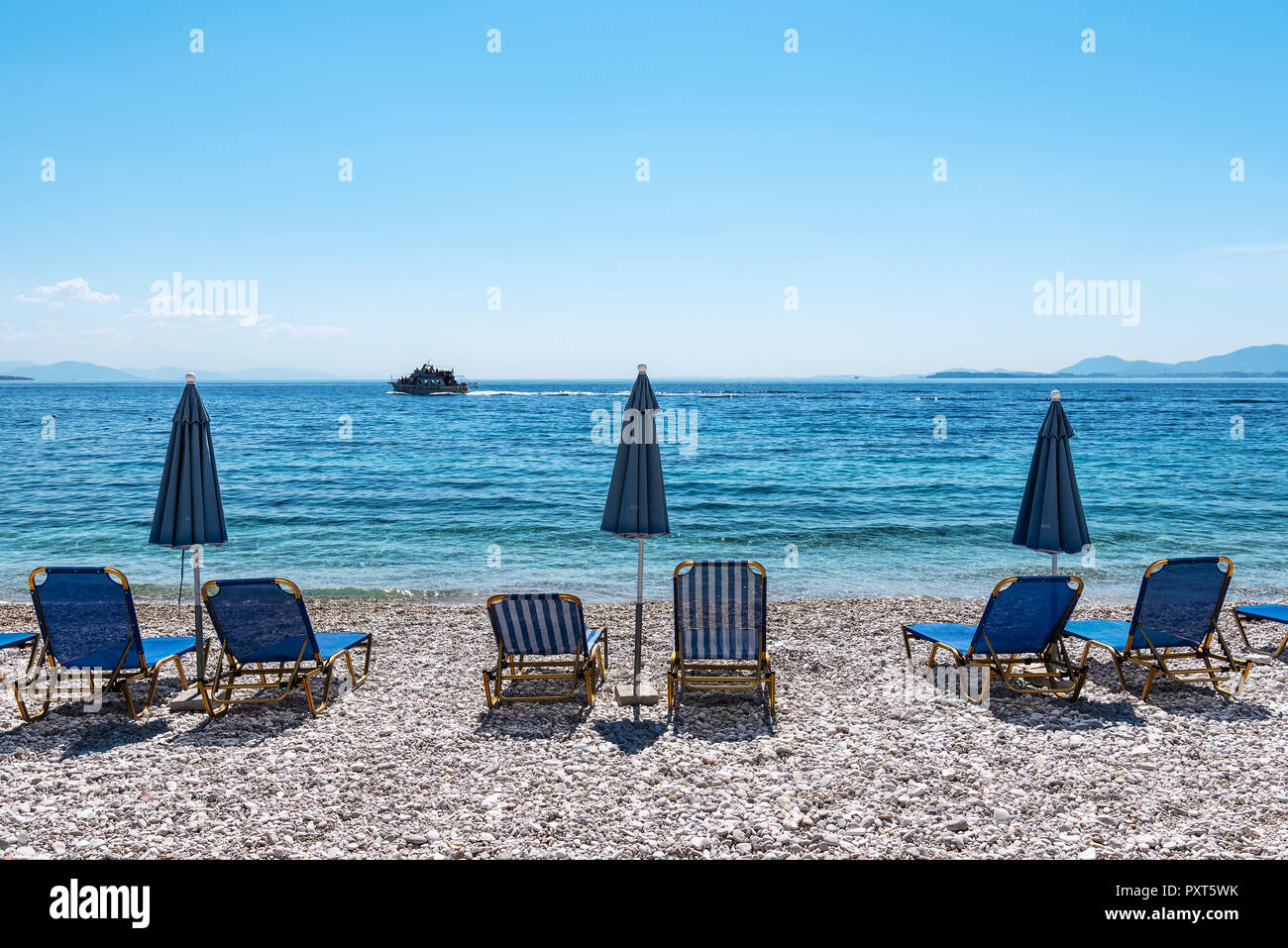 Deckchairs at Kaminaki Beach, Nissaki, Corfu Island, Ionian Islands, Mediterranean Sea, Greece Stock Photo