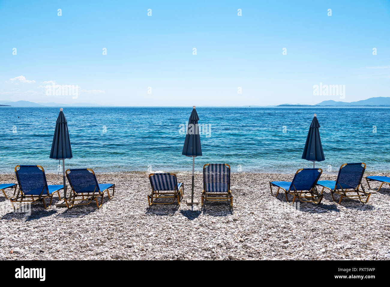 Deckchairs at Kaminaki Beach, Nissaki, Corfu Island, Ionian Islands, Mediterranean Sea, Greece Stock Photo