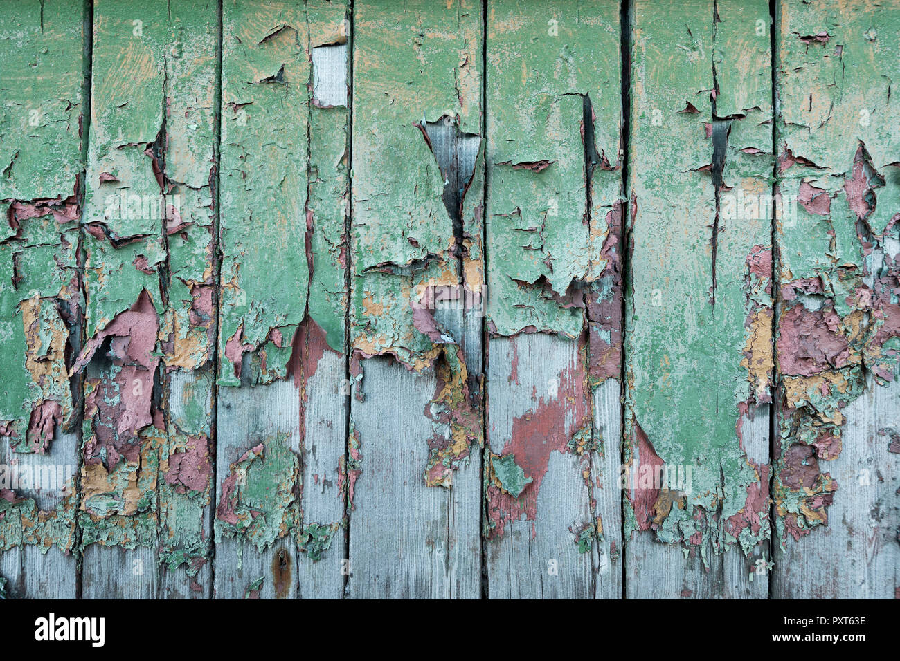 Peeling green and red paint on wooden wall, Russian miners settlement Barentsburg, Isfjorden, Spitsbergen Stock Photo