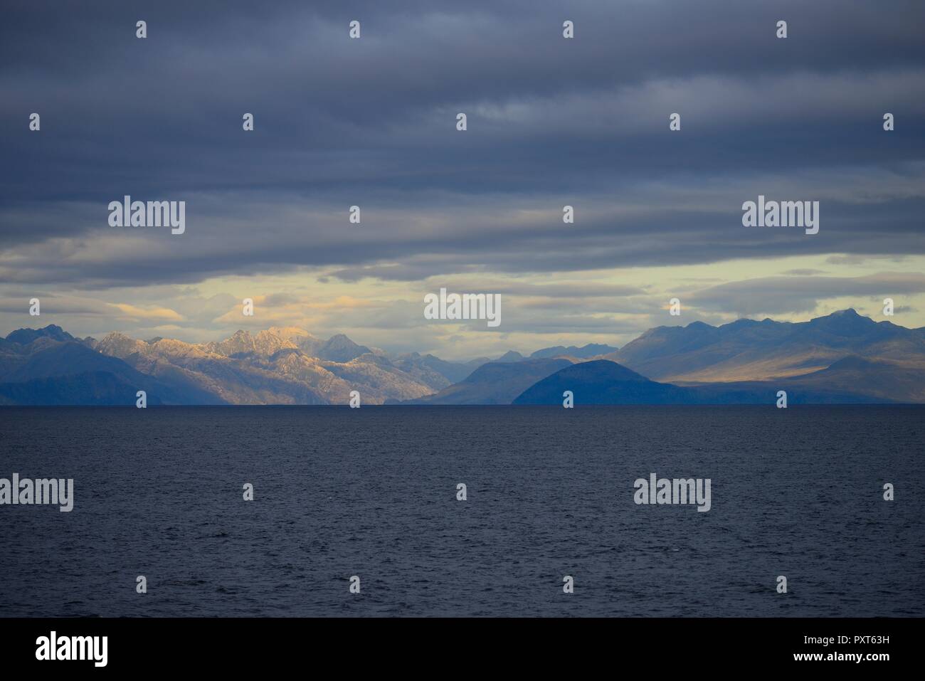 Coastal landscape with dark clouds, South Pacific, near Puerto Natales, Patagonia, Chile Stock Photo
