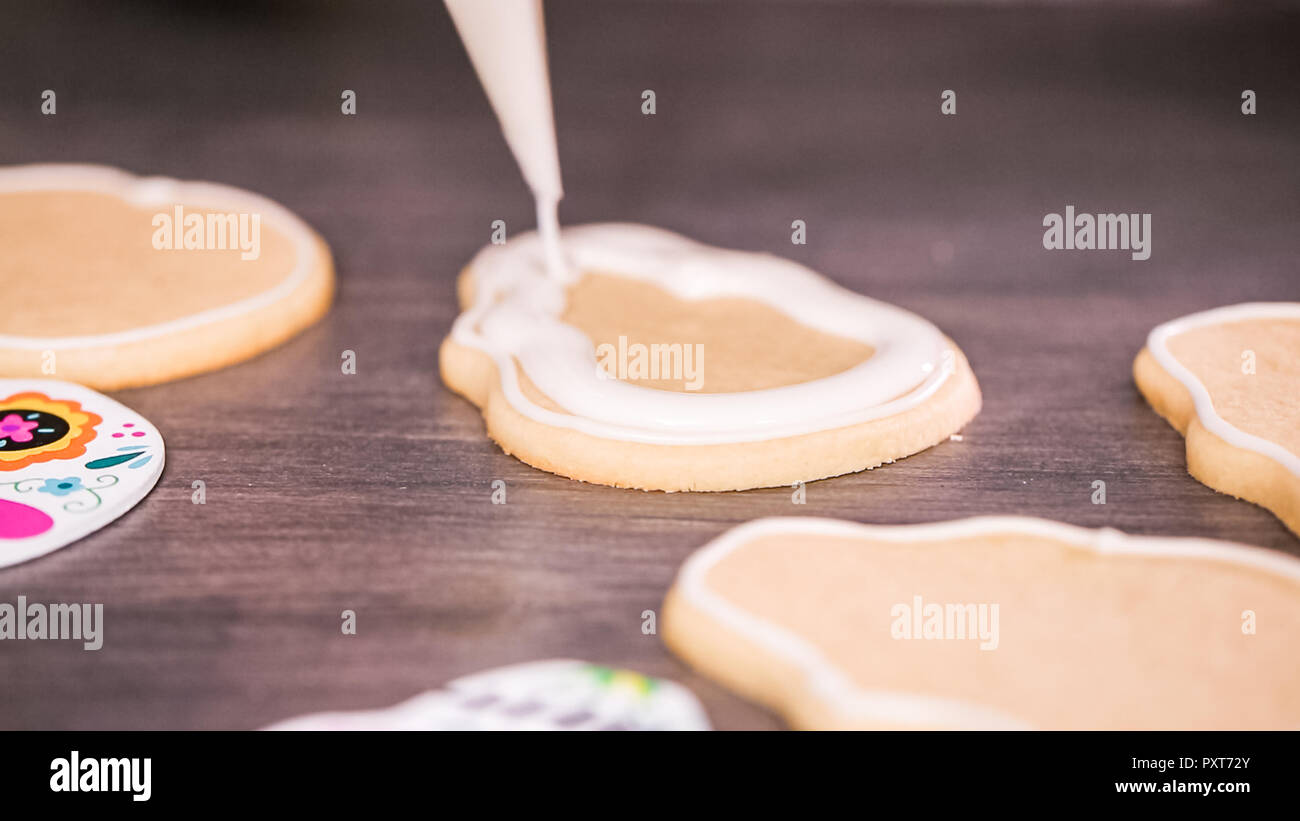 Step by step. Flooding a sugar skull cookie with white royal icing