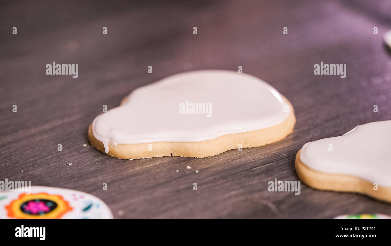 Step by step. Flooding a sugar skull cookie with white royal icing