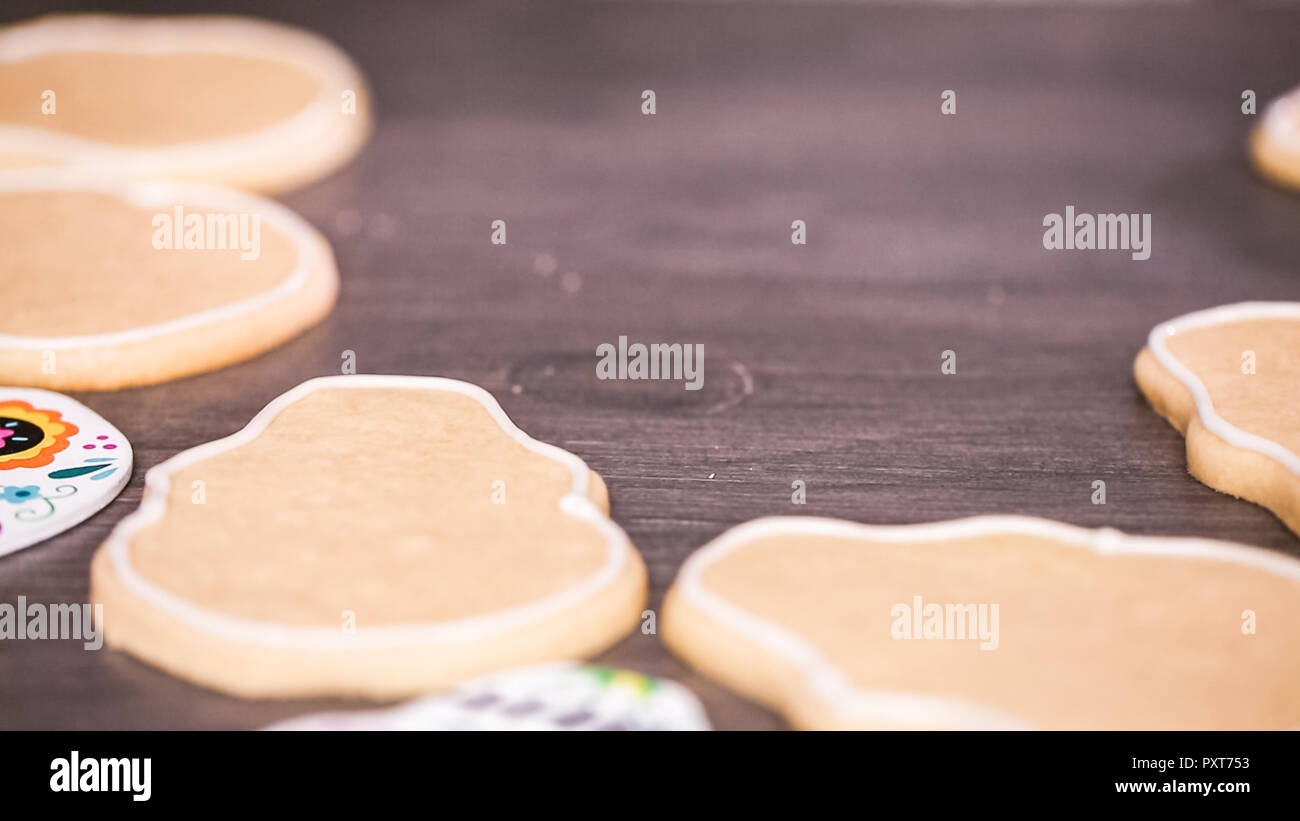 Step by step. Creating edge for flooding sugar skull cookie with royal icing. Stock Photo