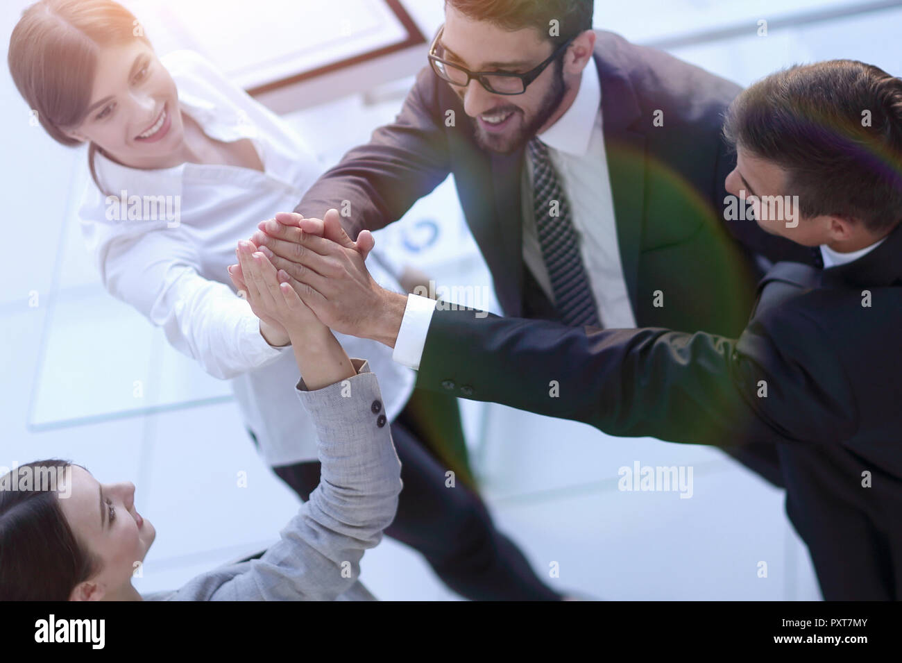 successful business team giving each other a high-five, standing in the ...