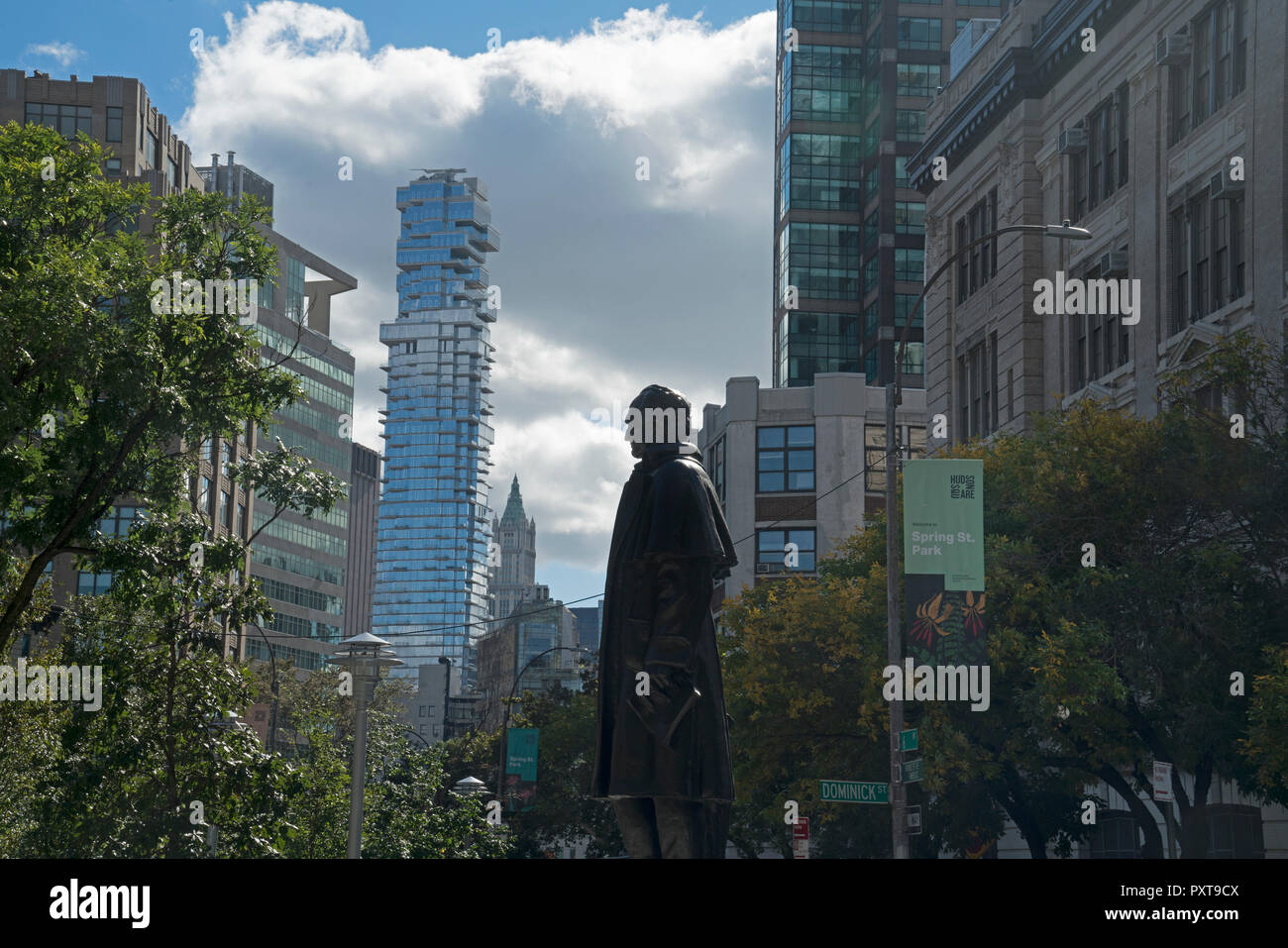 A statue of Uruguayan hero José Artigas stands in Spring Street Park in Manhattan's Soho neighborhood, with the Woolworth Building in the distance. Stock Photo
