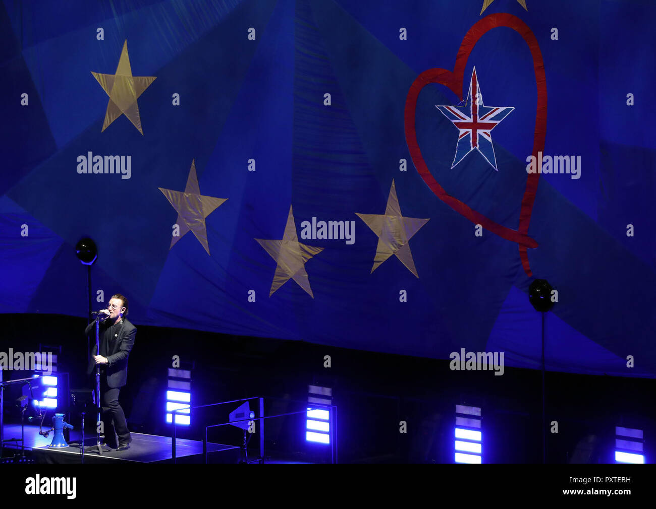 U2's Bono performs in front of a giant EU flag, with one star as the Union Flag, at the o2 Arena in London, during their eXPERIENCE + iNNOCENCE Tour. Stock Photo