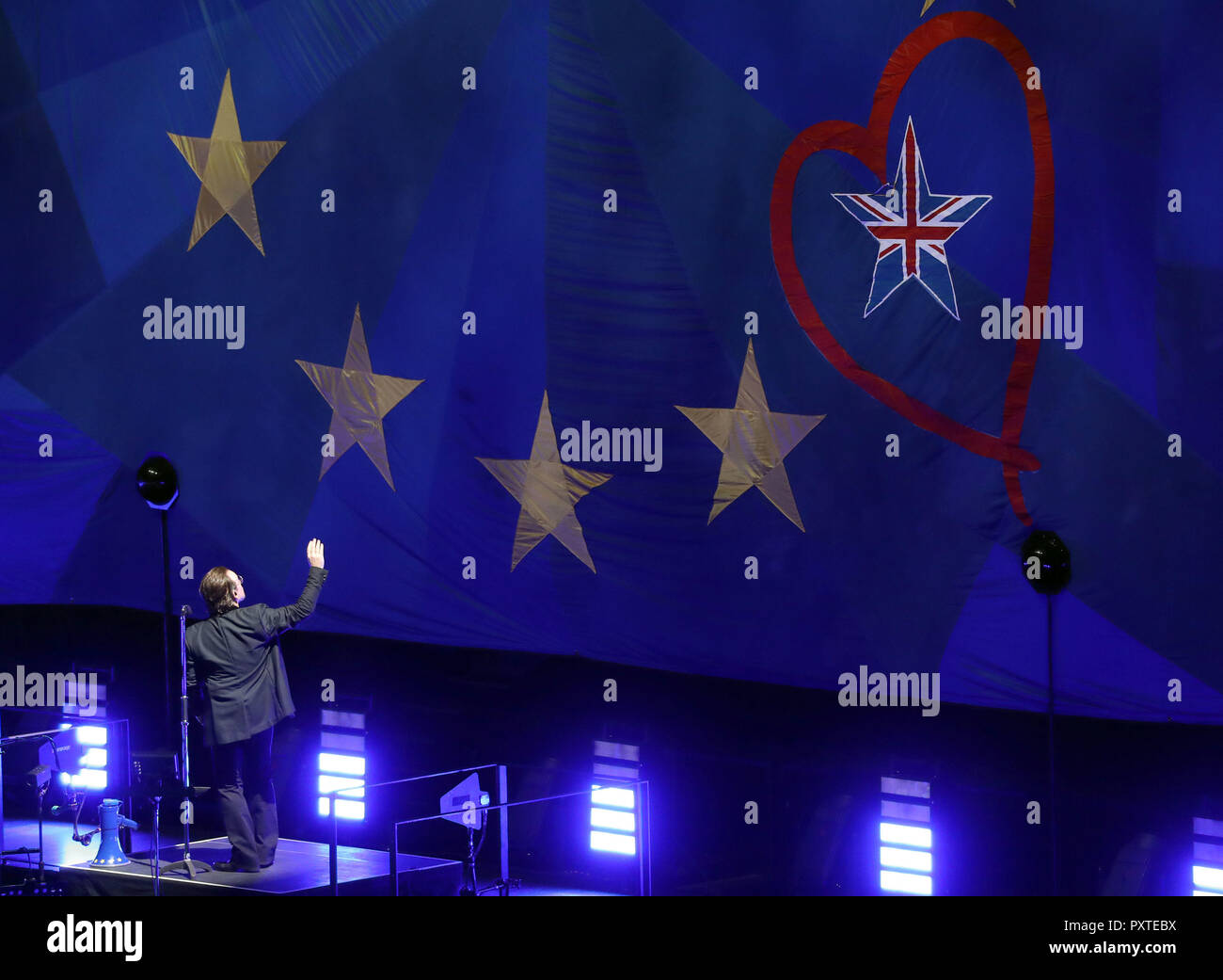 U2's Bono waves to a giant EU flag, with one star as the Union Flag, at the o2 Arena in London, during their eXPERIENCE + iNNOCENCE Tour. Stock Photo