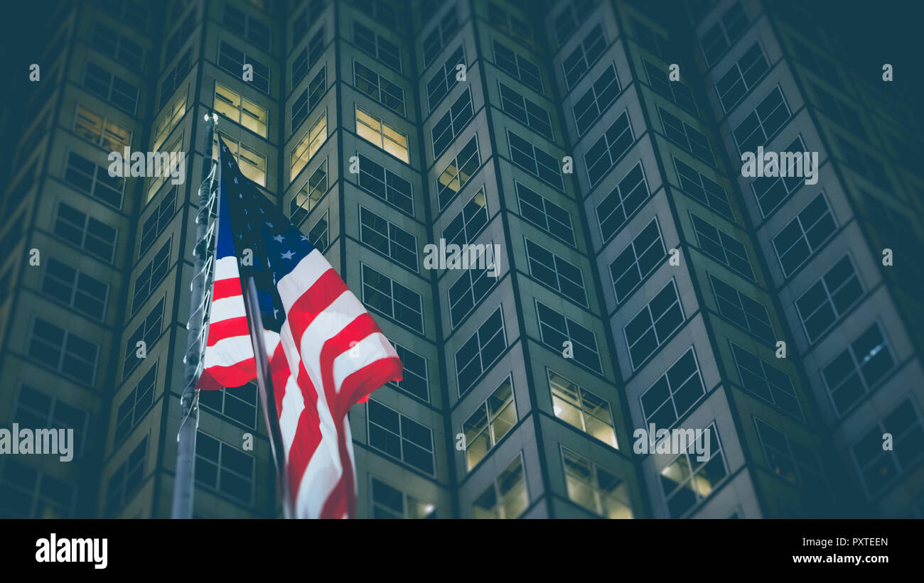 USA flag in front of business building at night, business and economy concept Stock Photo