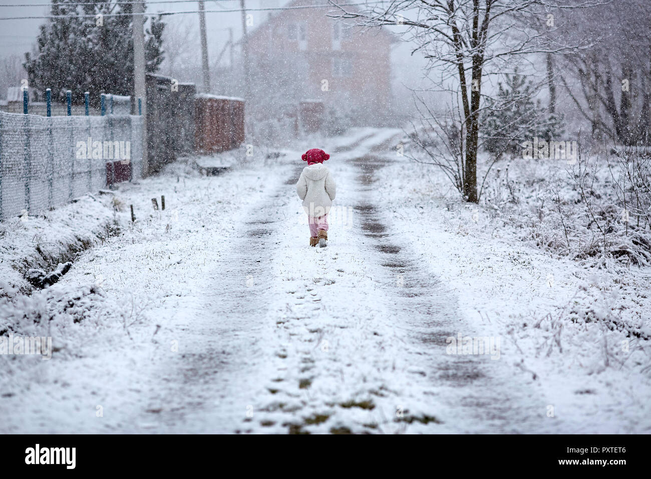 Girl at the snowy background hi-res stock photography and images - Alamy