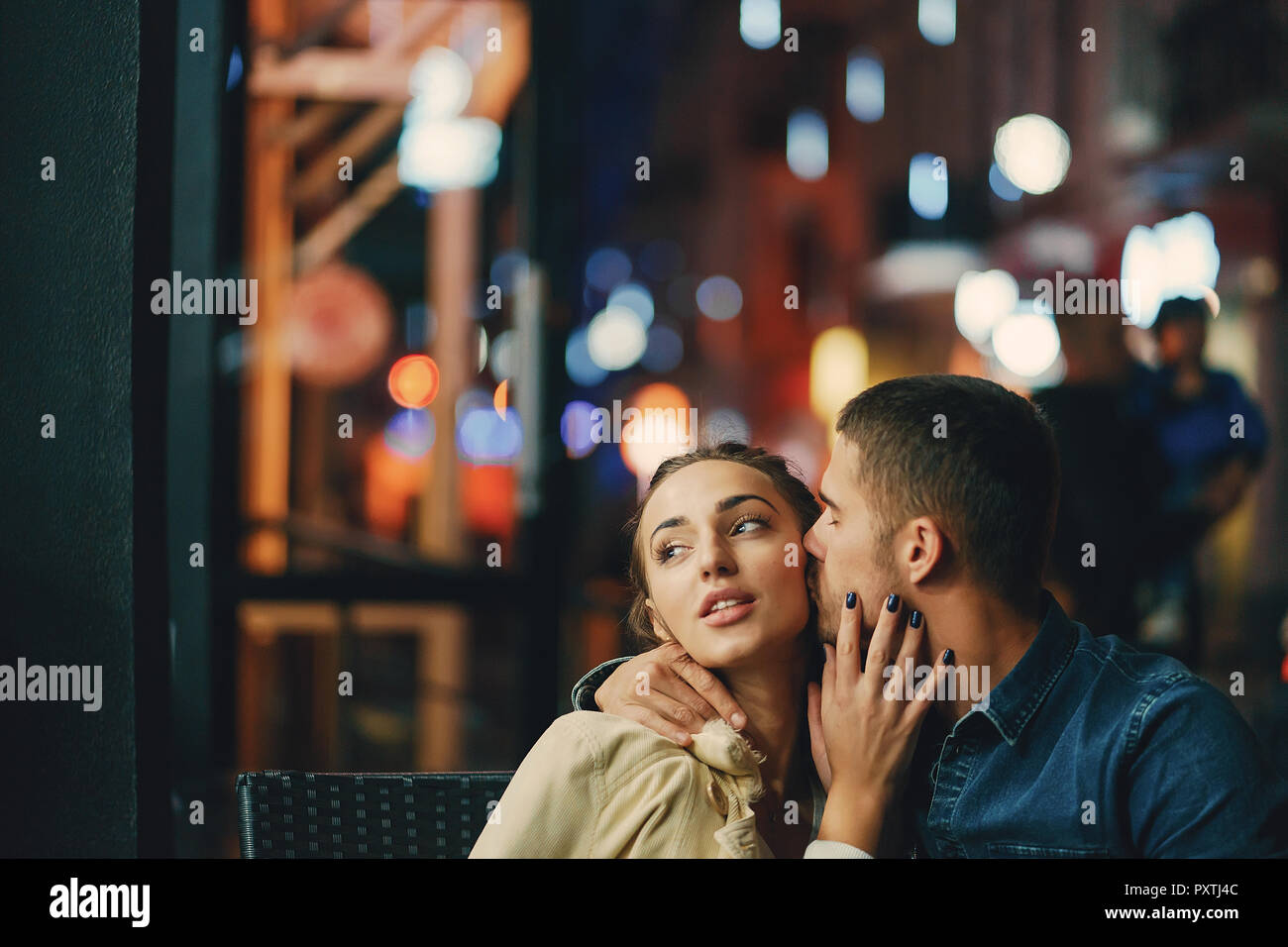 couple drinking coffee outside a restaurant at night Stock Photo Alamy