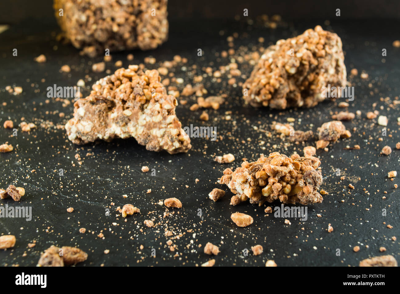 Chocolate with puffed rice and raisins with crumbles over dark ...