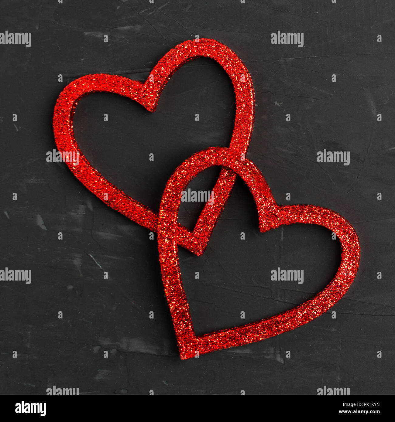 Two red shiny hearts on grey background Stock Photo - Alamy