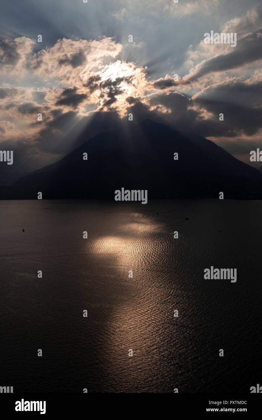 Sunburst over Lake Como in the Italian mountains Stock Photo