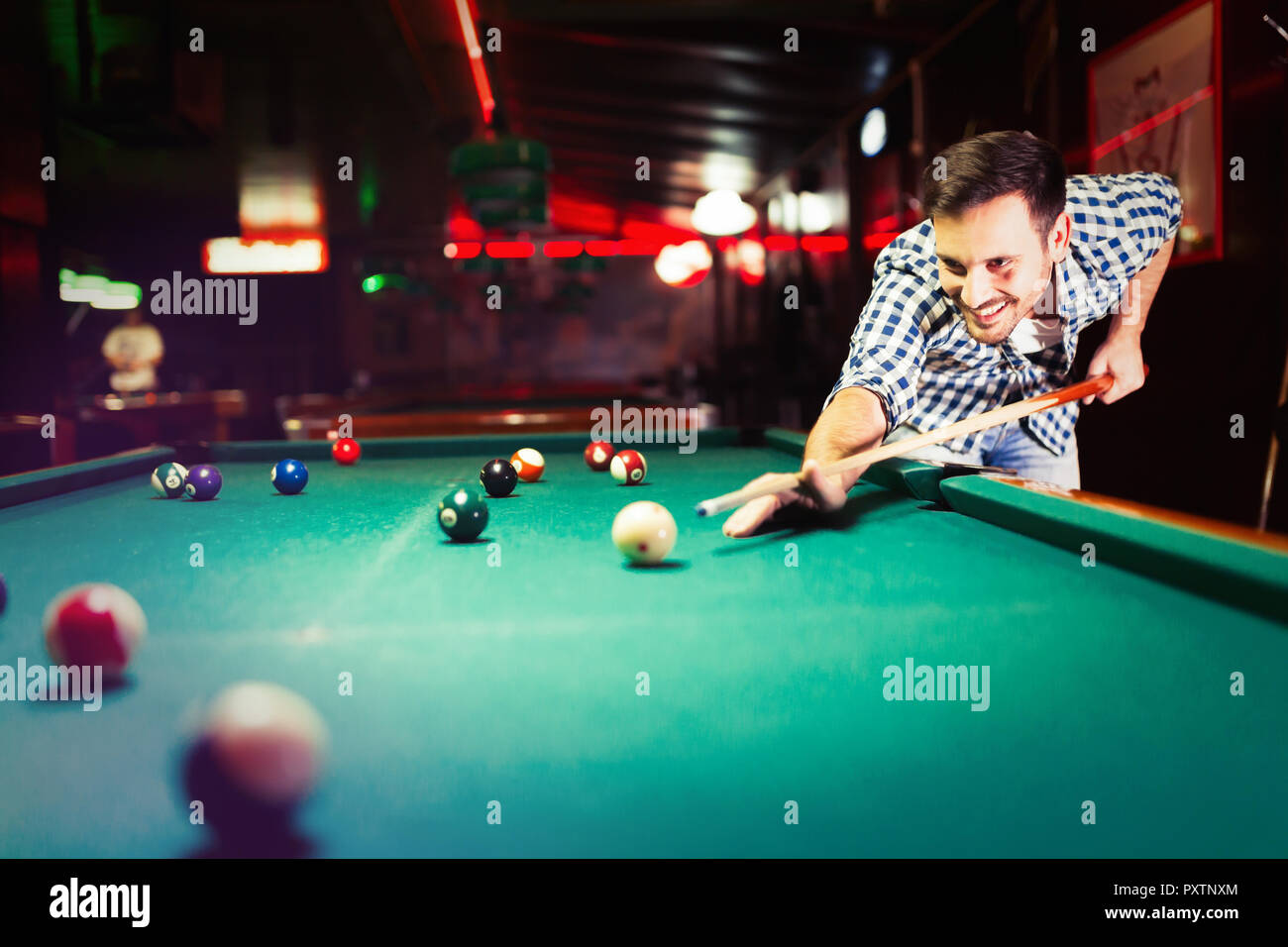Hansome man playing pool in bar alone Stock Photo