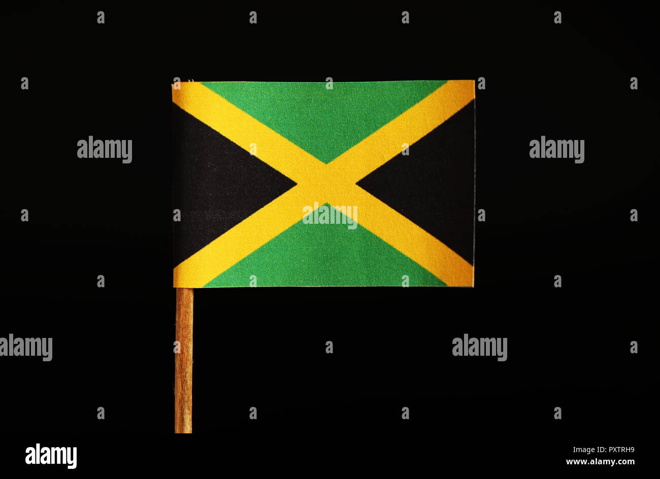 A official and original Flag of Jamaica on toothpick and on black background. Jamaica located in the central america. It know as land of weed Stock Photo