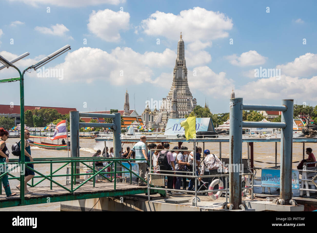 Bangkok, Thailand - 26th Sept 2018: Tourists board the ferry across to Wat Arun. The temple is a popular tourist attraction. Stock Photo