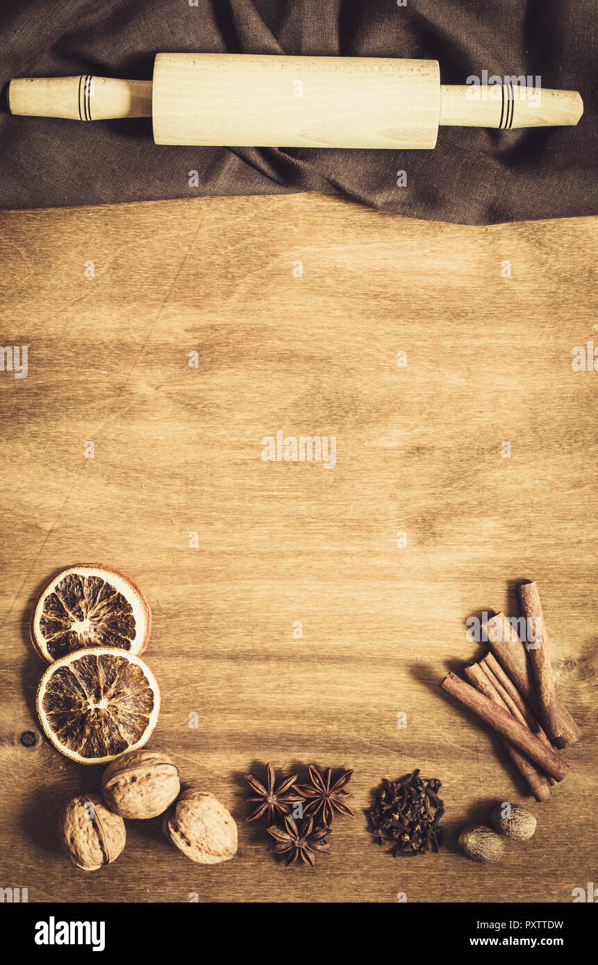 Culinary Background. Spices and tools for Christmas Baking on a Wooden Table. Top view. Copy space. Selective focus. Toned image. Stock Photo