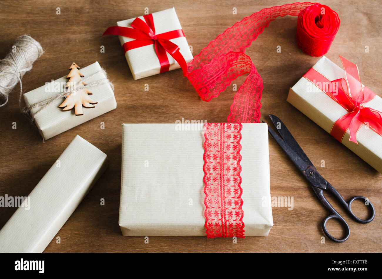 Packing Christmas Gifts. Top View of Festive Boxes in Brown Paper