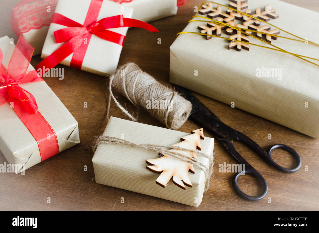Packing Christmas Gifts. Top View of Festive Boxes in Brown Paper