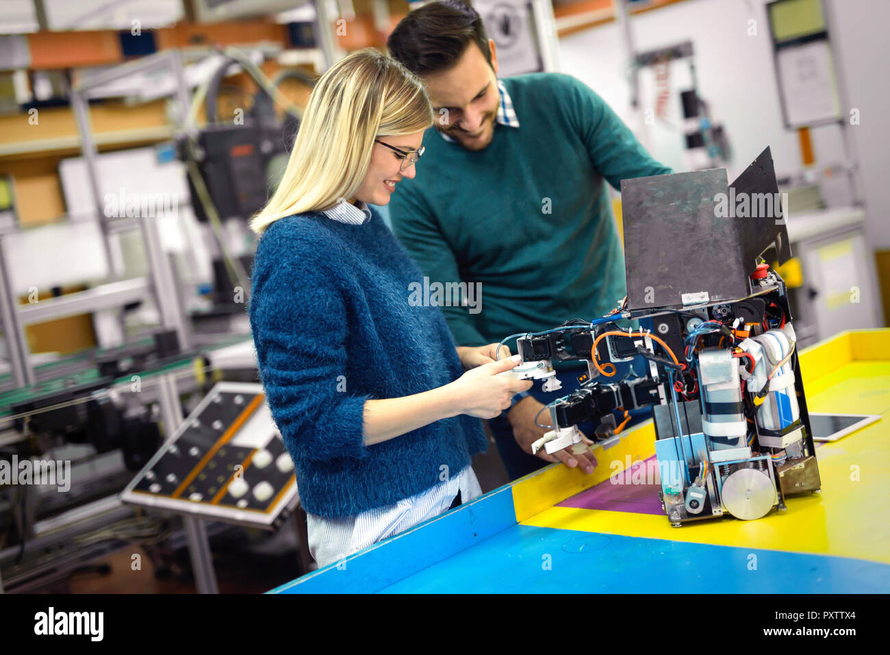 Young attractive students of mechatronics working on project Stock Photo