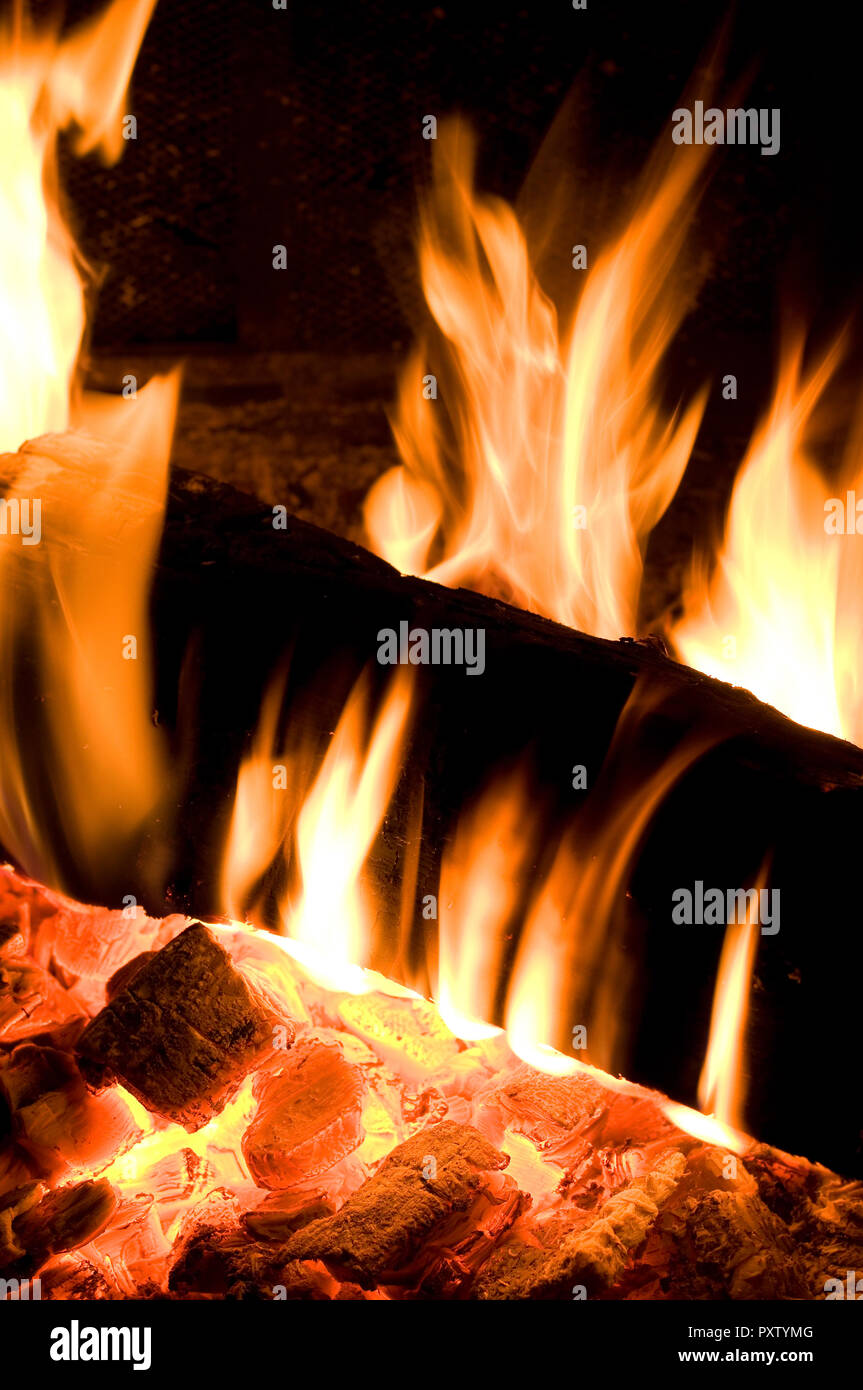 Vertical Image of Fire Log Burning Intensively in Firepit Stock Photo