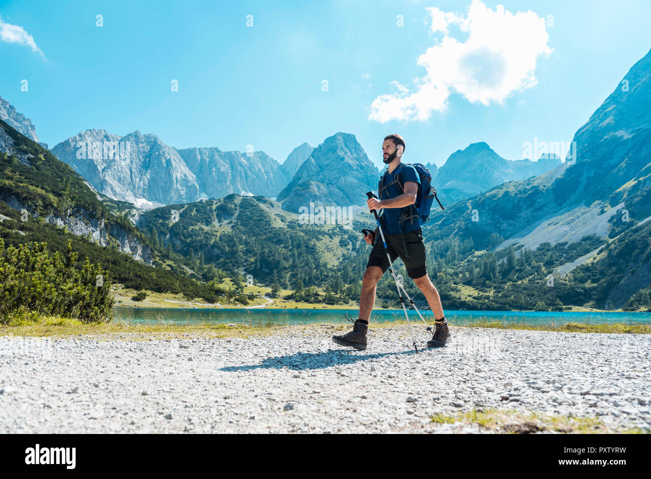 Austria, Tyrol, Man hiking at Seebensee Lake Stock Photo