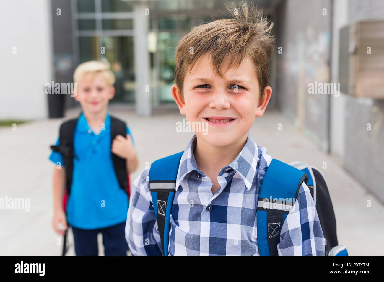 students outside school standing together on the day of school Stock Photo