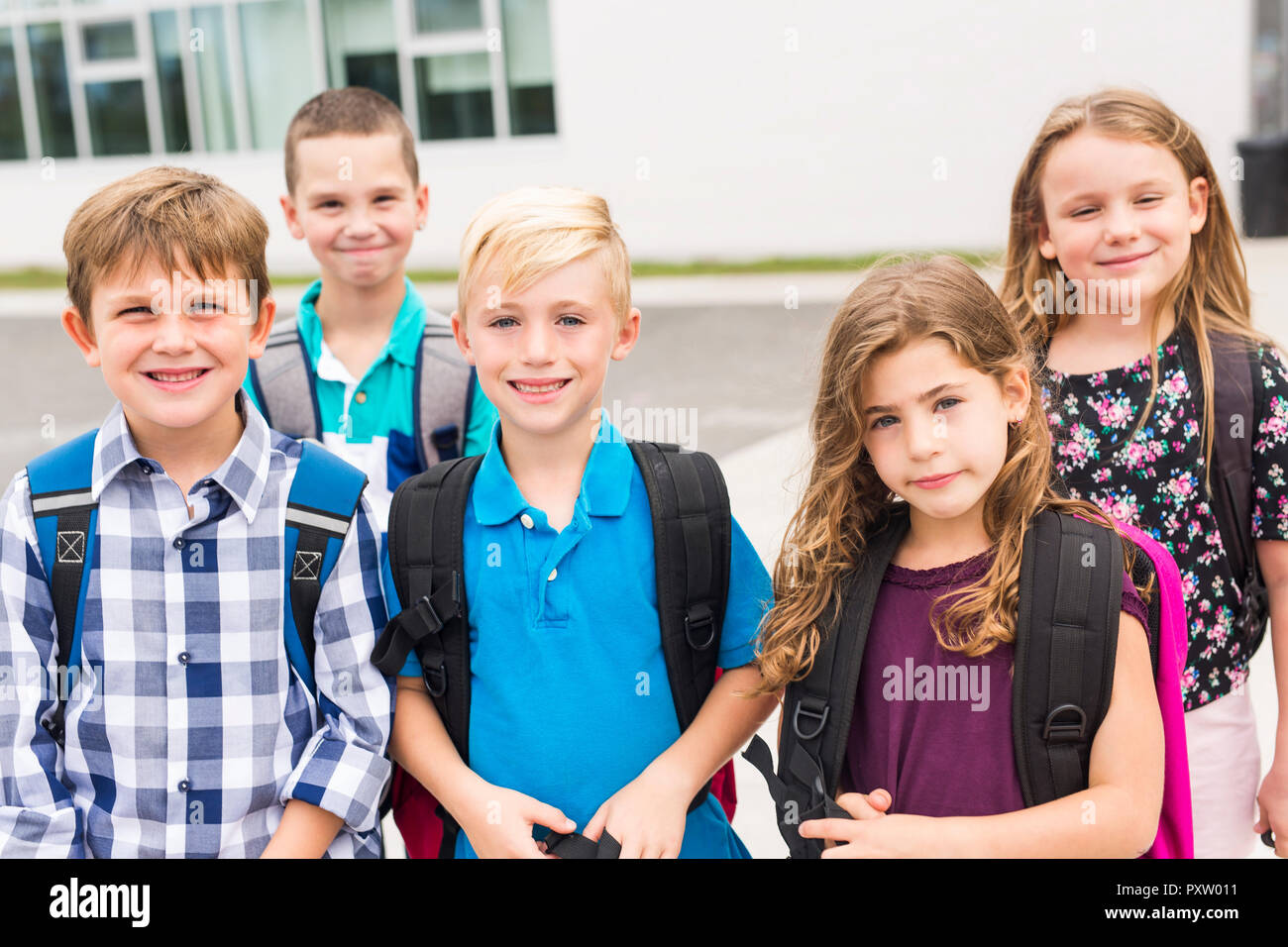 Great group Portrait Of School Pupil Outside Classroom Carrying Bags ...