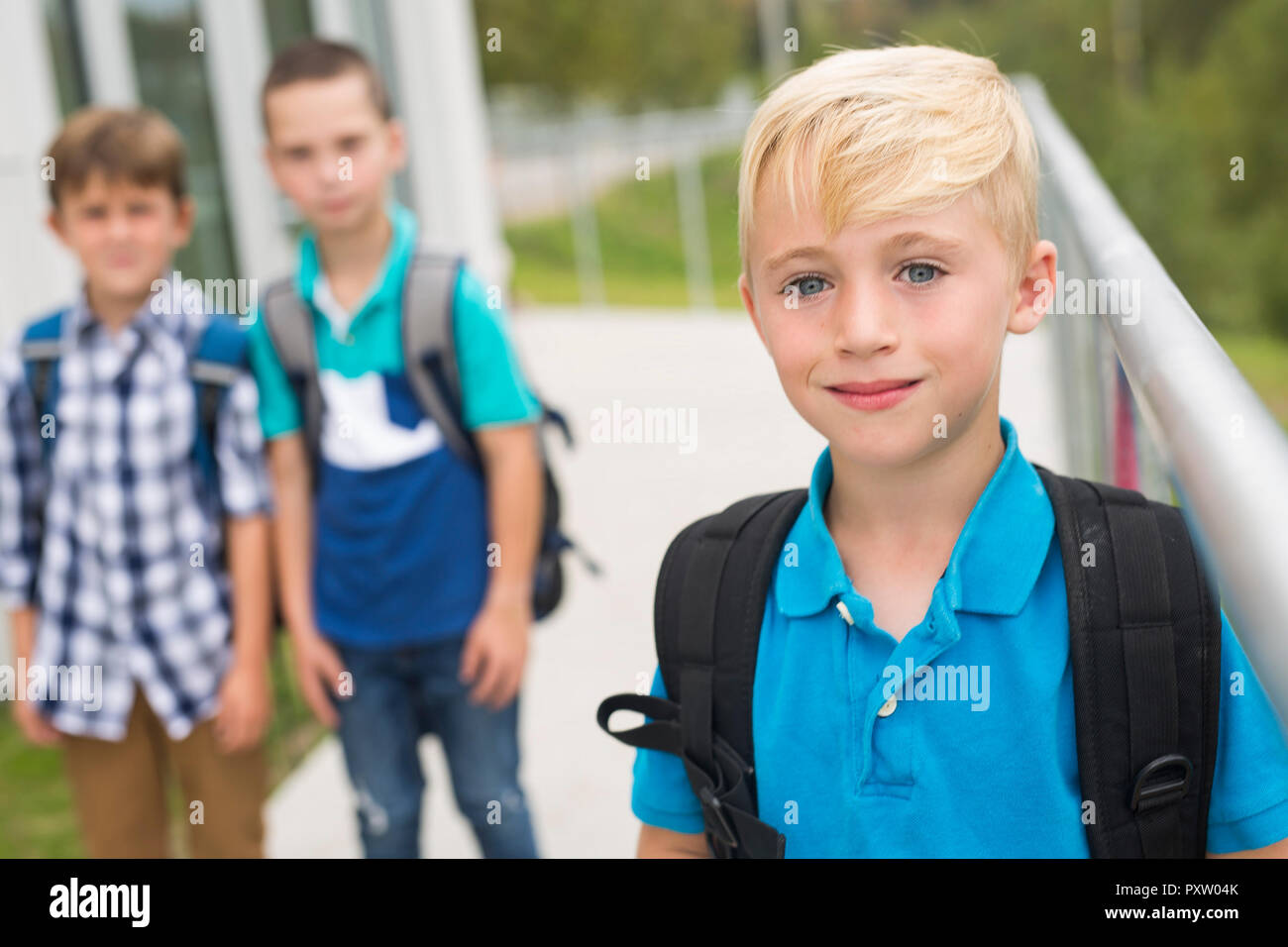 students outside school standing together on the day of school Stock Photo