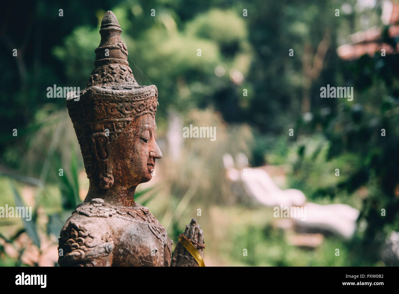 Thailand, Chiang Mai, Buddhist statue in the middle of the jungle in Wat Pha Lat Buddhist temple Stock Photo