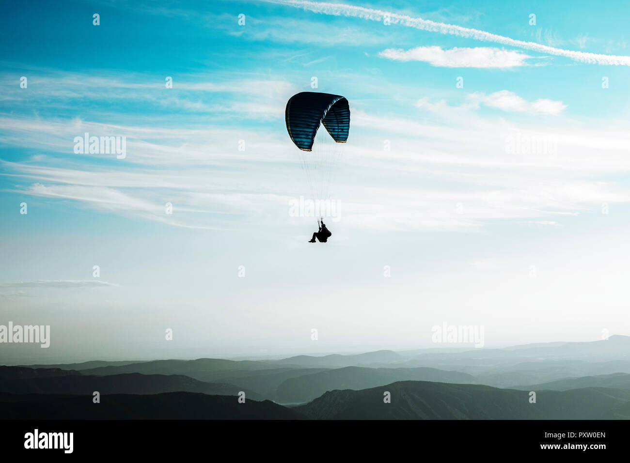 Paragliding, paraglider, blue sky with clouds, mountains Stock Photo Alamy
