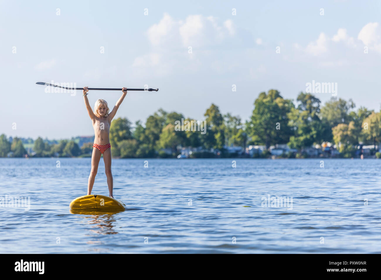 Young girl stand up paddle surfing Stock Photo