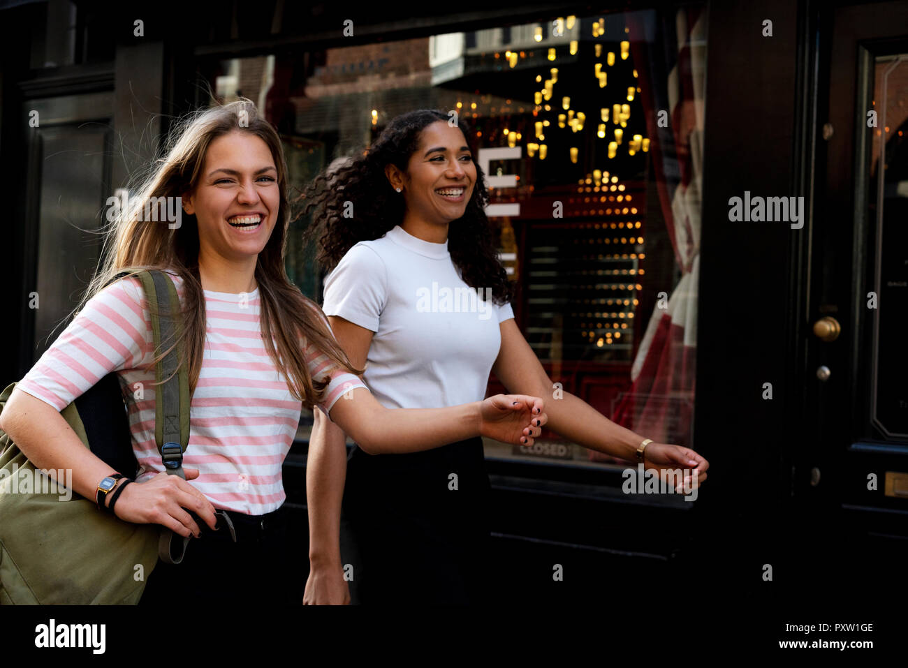 Two girlfriends on a city break, going on a shopping spree Stock Photo