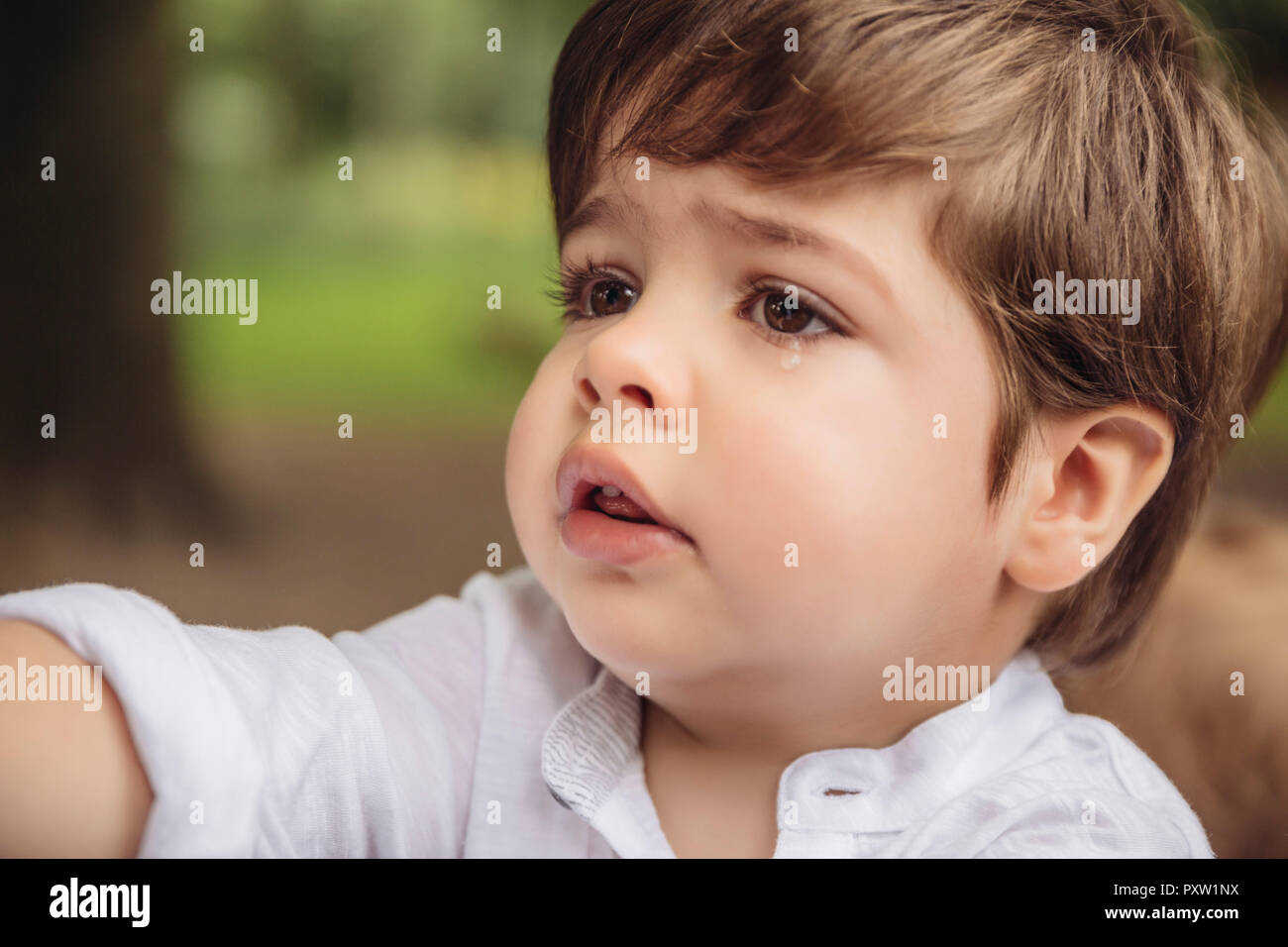 Portrait of unhappy toddler with tear in his eye Stock Photo