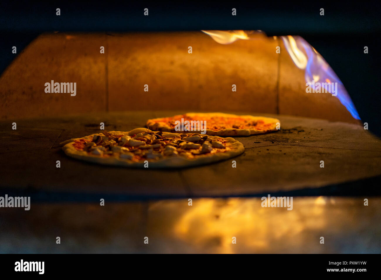 Two pizzas in oven Stock Photo Alamy