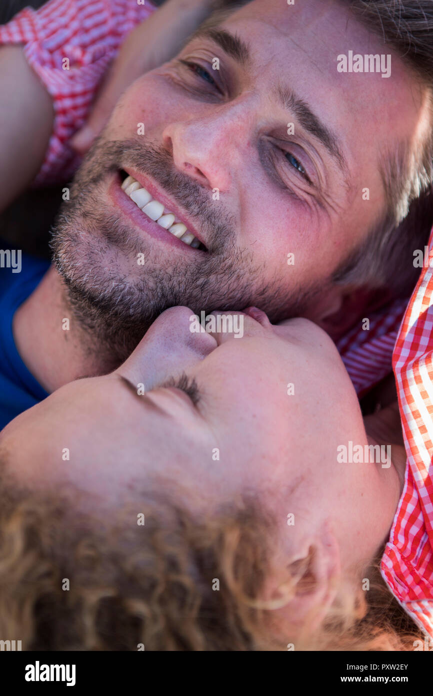 Happy affectionate couple lying down Stock Photo