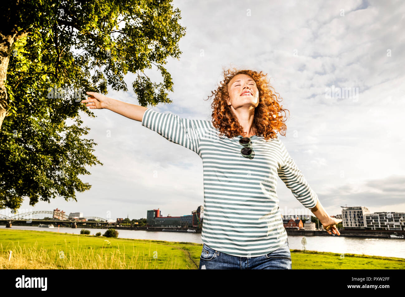 Germany, Cologne, young woman enjoying sunlight Stock Photo