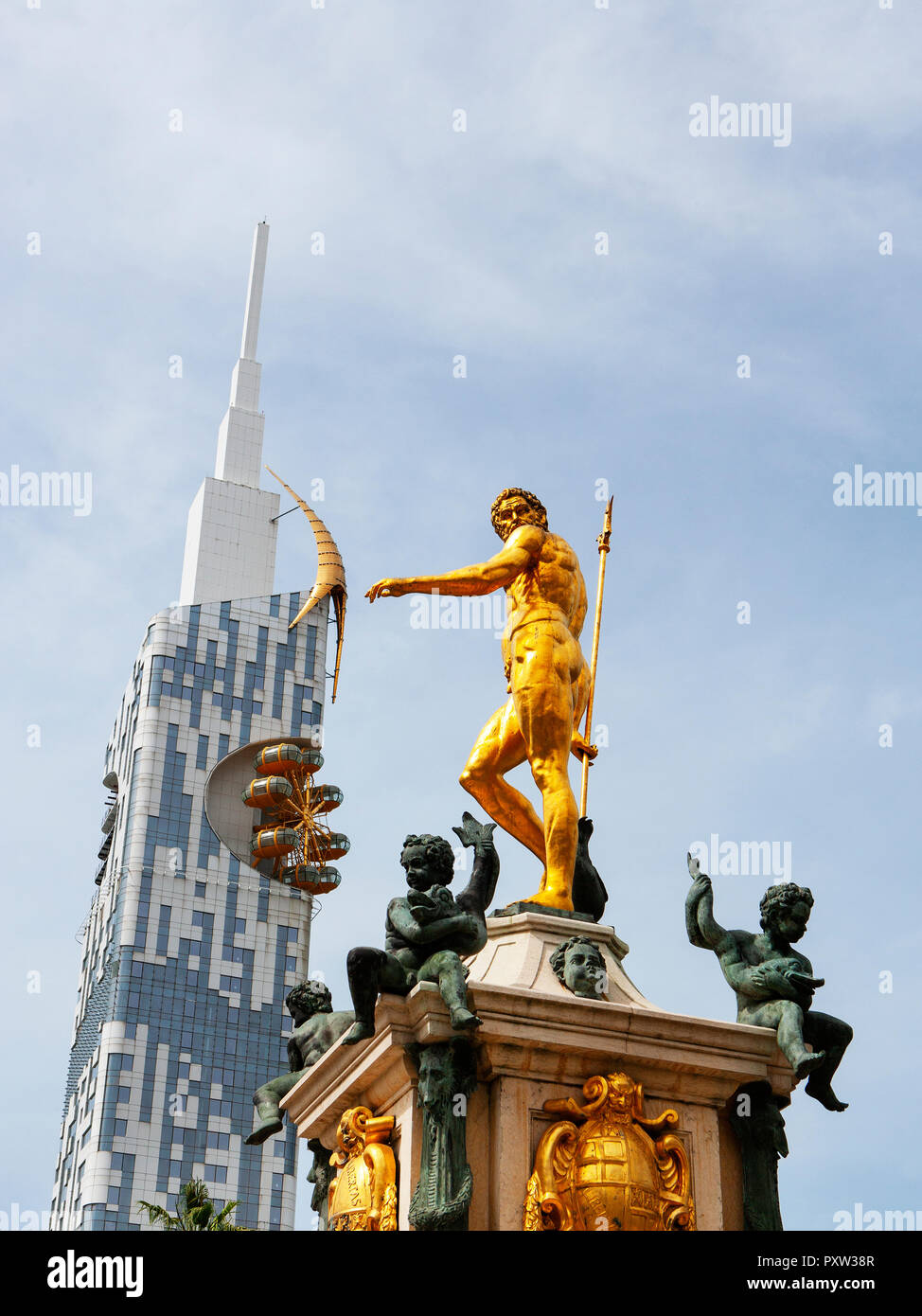 Georgia, Adjara, Batumi, Golden sculpture on the Neptune fountain with technical university in background Stock Photo