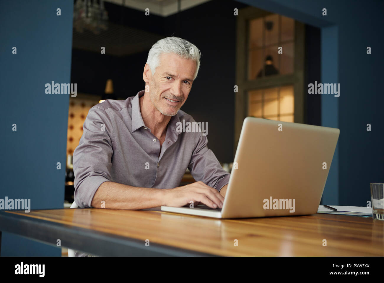 Laptop at table hi-res stock photography and images - Alamy
