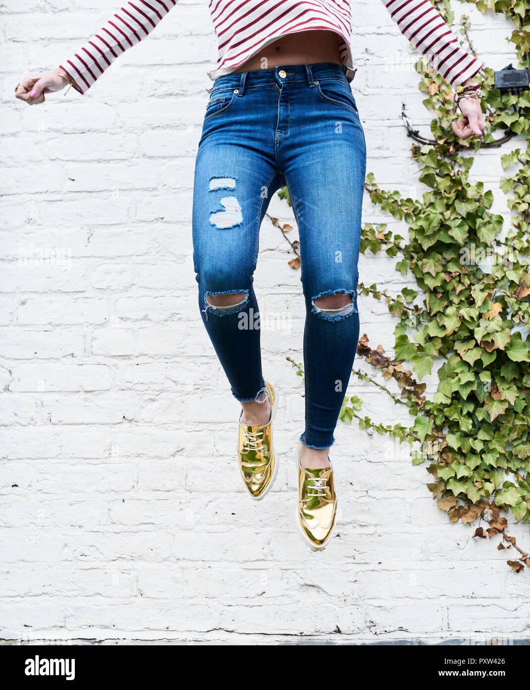 Legs of woman jumping in the air Stock Photo