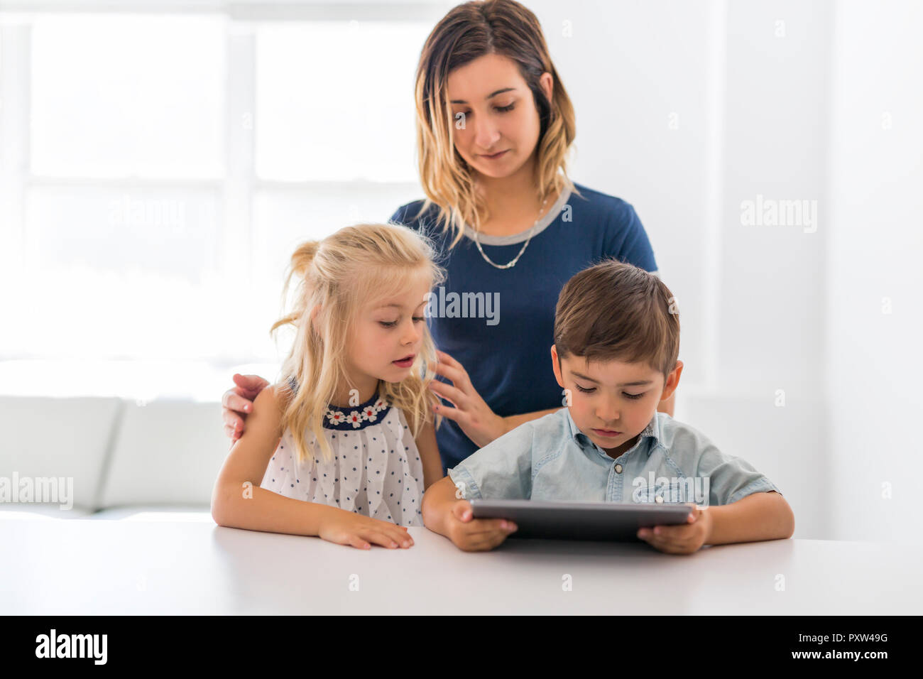 An Adorable brother and sister young child using tablet Stock Photo - Alamy