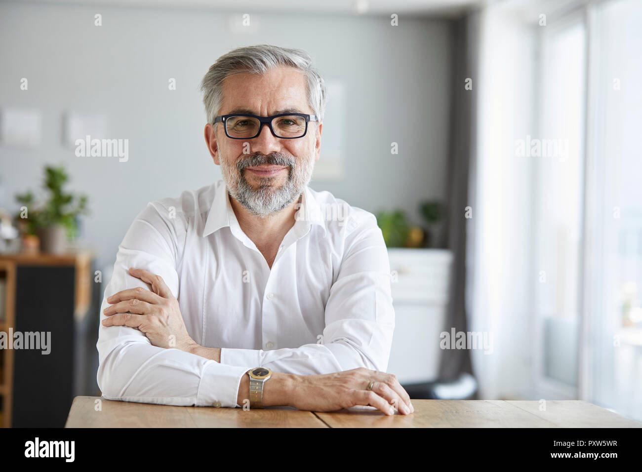 Portrait of content mature man at home Stock Photo