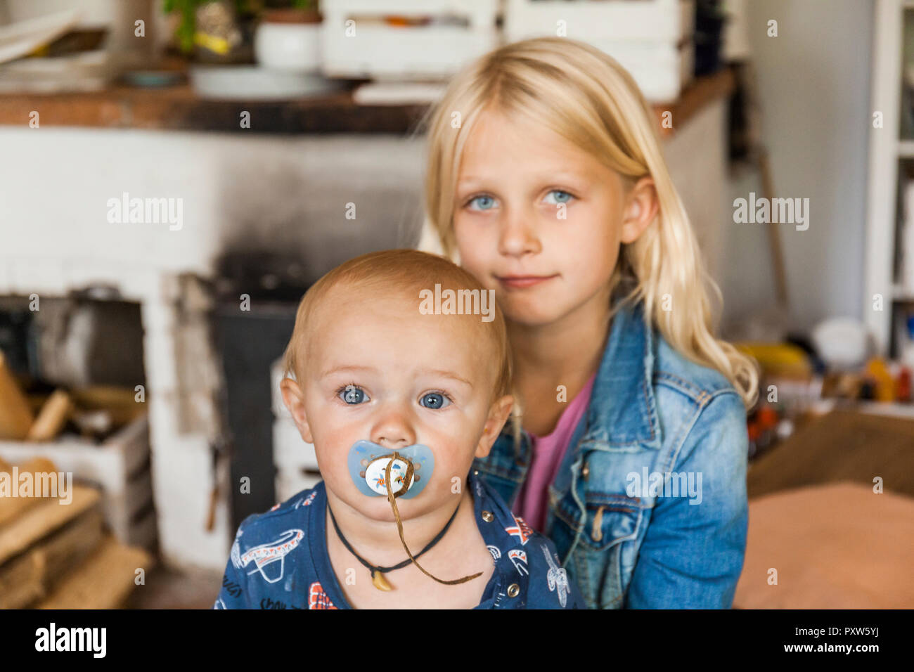 Portrait of girl with baby boy brother at home Stock Photo