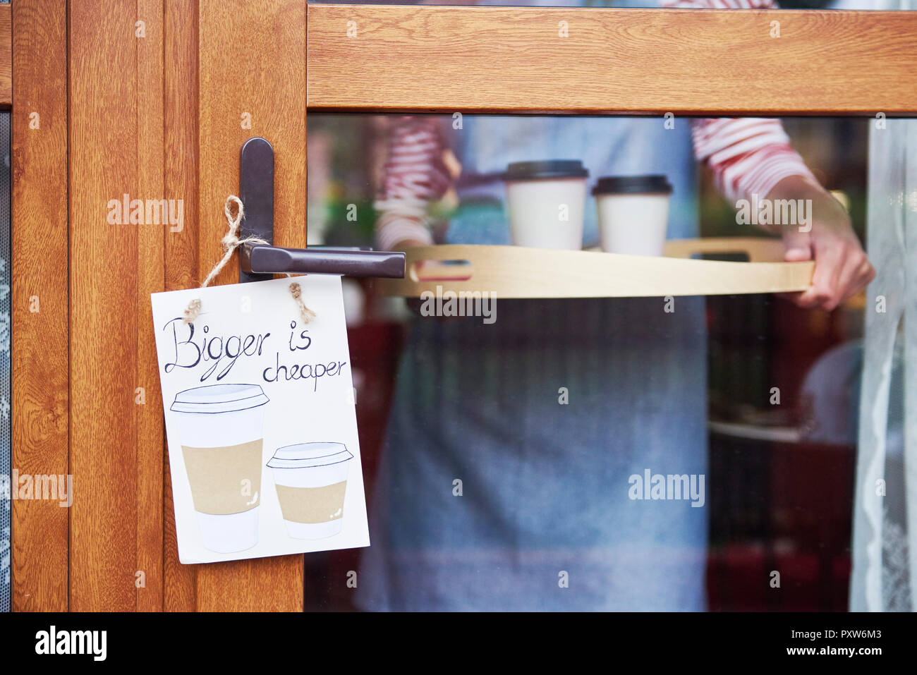 Close-up of woman serving tray with coffee in a cafe Stock Photo