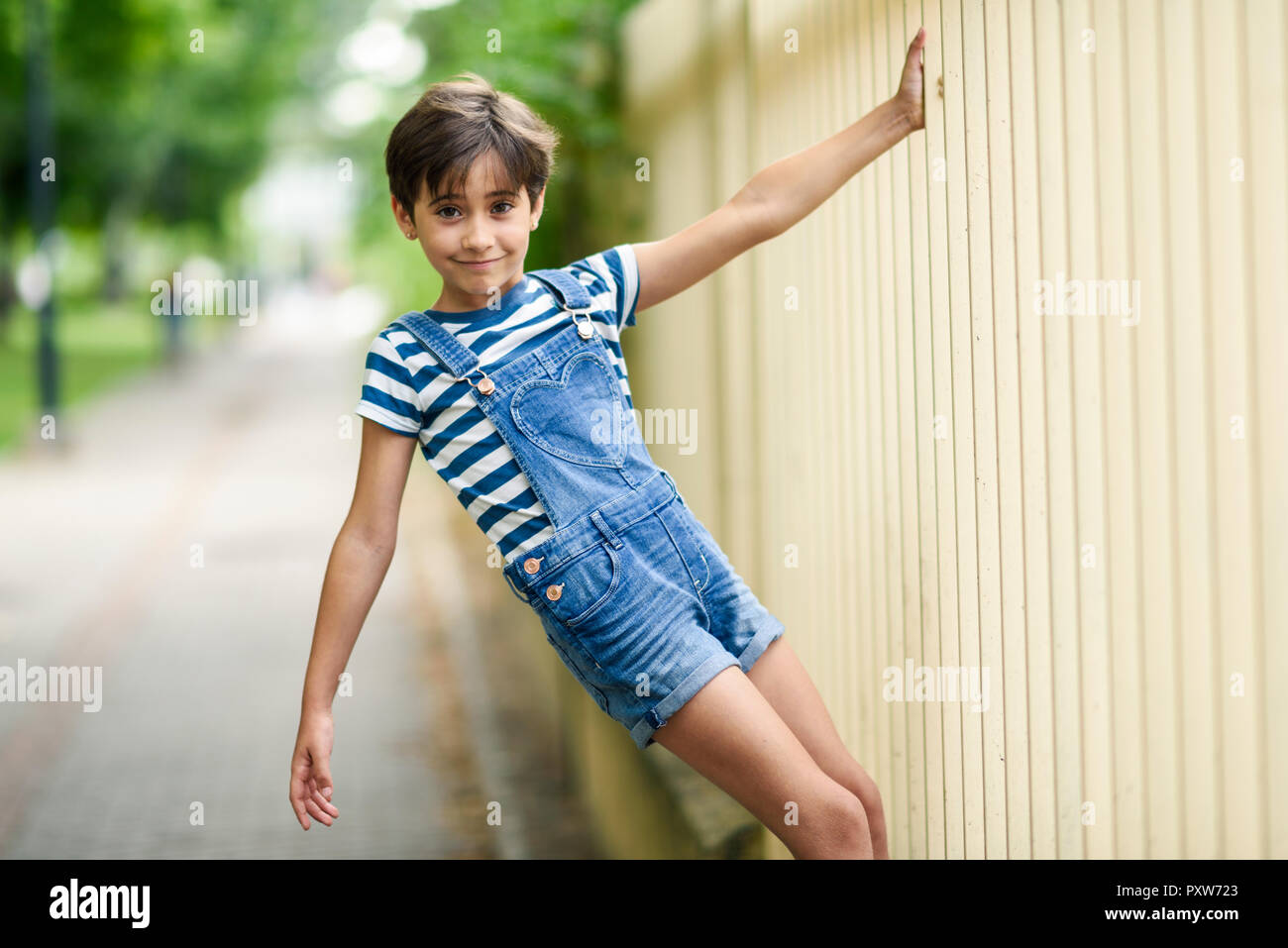 Portrait of smiling little girl playing outdoors Stock Photo