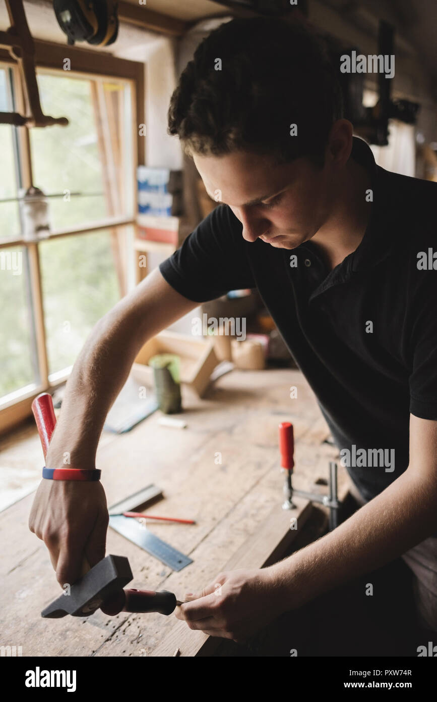 Carpenter working on piece of wood in workshop Stock Photo