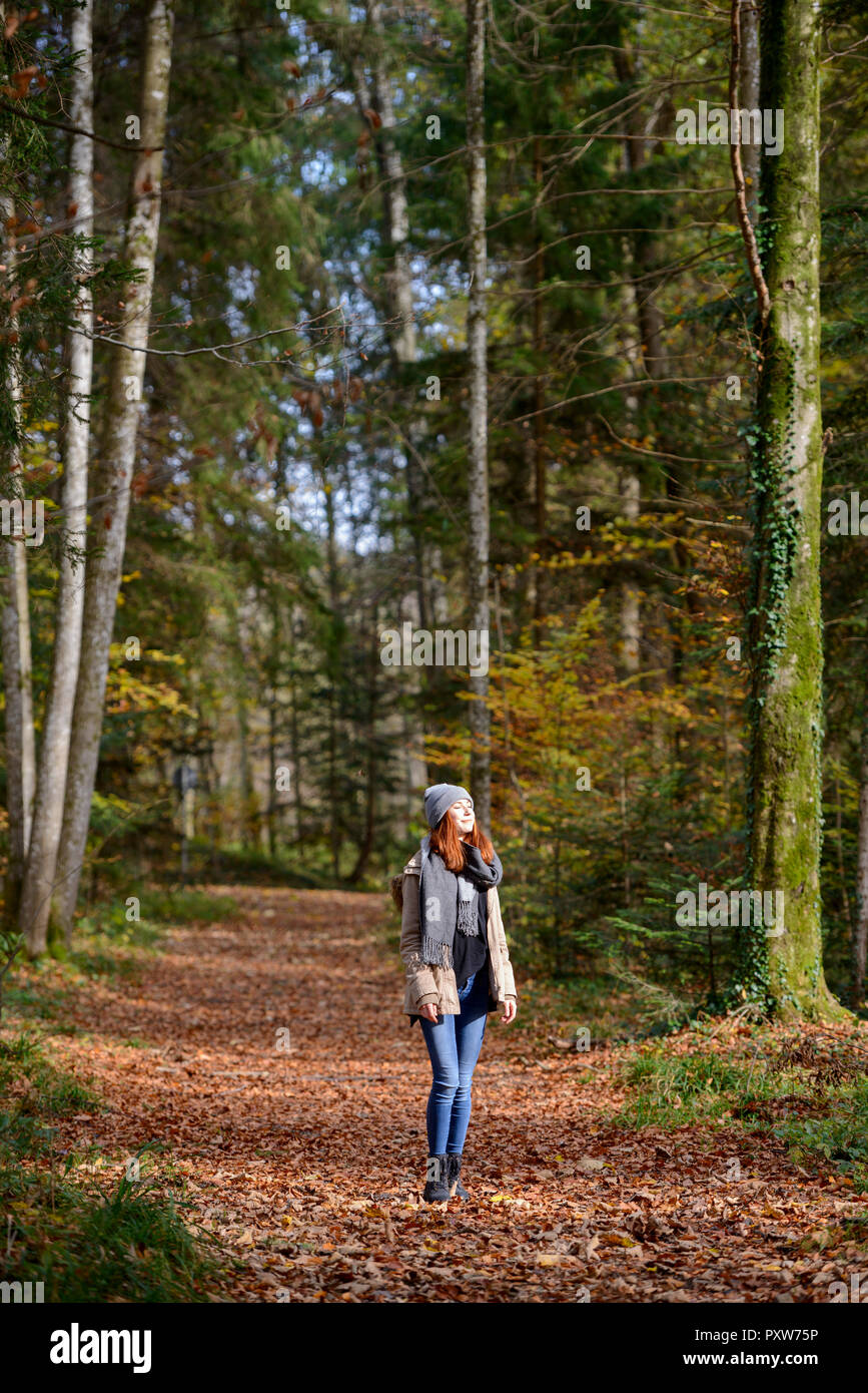 Redheaded teenage girl enjoying autumnal forest Stock Photo